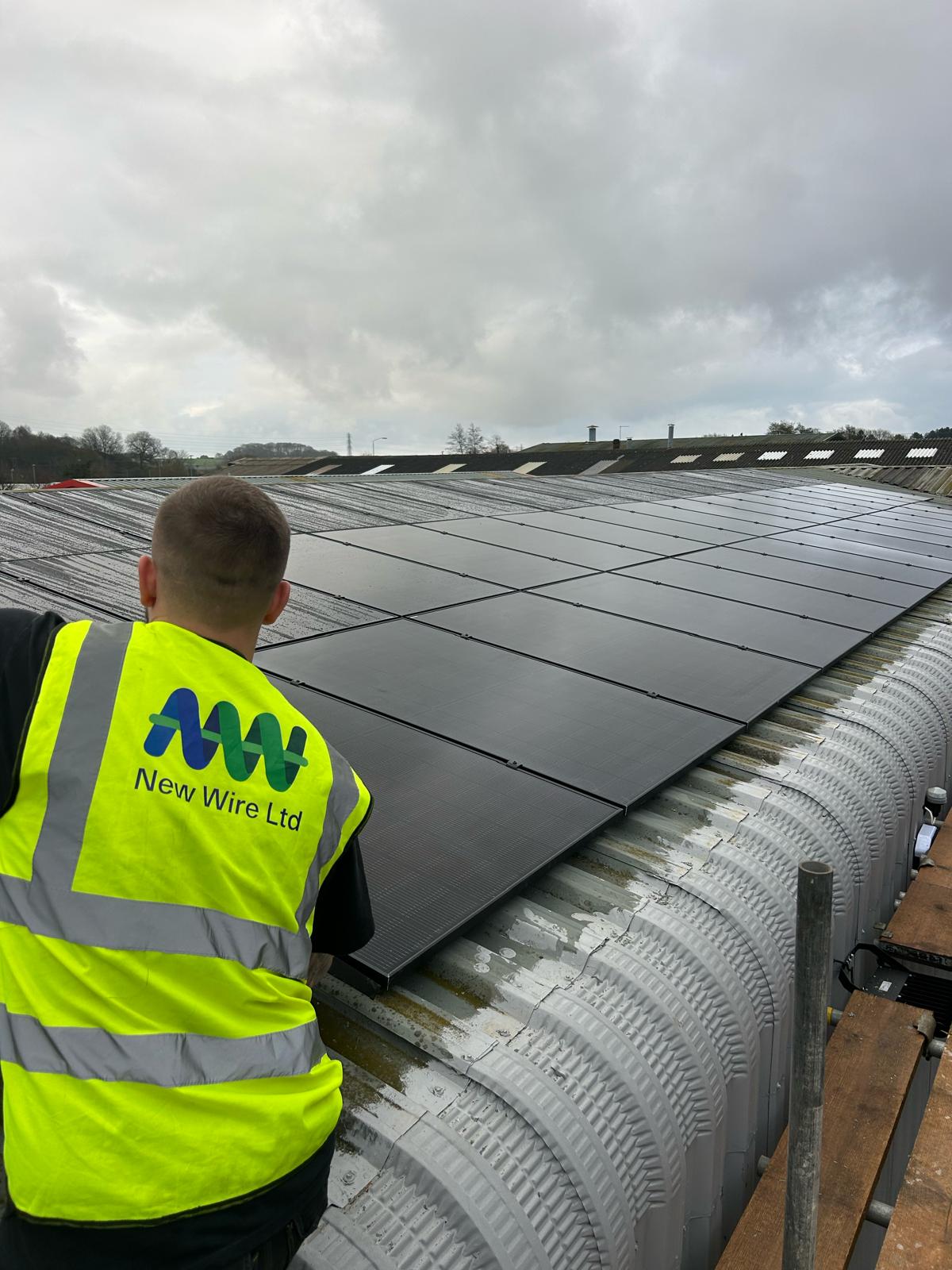 Solar panels being installed on a warehouse roof